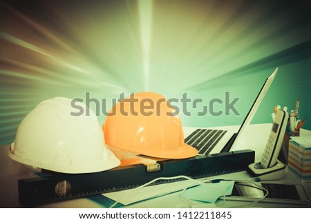 Engineering tools on office desk on background of bright divergent rays