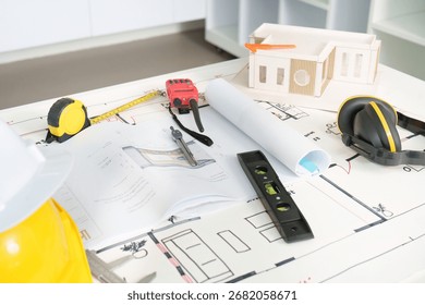 Engineering tools and plans for construction project on a table