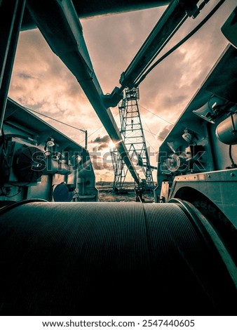 Engineering View from geophysical unit during wireline operations in oil and gas field . Old oil rig on the background. Low color photography.