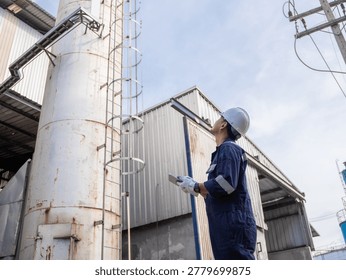Engineering work using digital tablet maintenance Exhaust system concept Clean air environmental protection. Factory industrial manufacturing. Sustainable future environment air pollution reduction