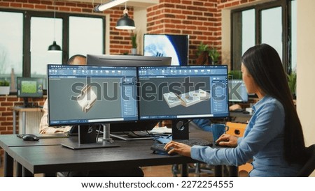 Engineering worker developing industrial component prototype on professional cad software, improving machine clamp. Asian graphic technician sketching 3D product or component, creative industry.