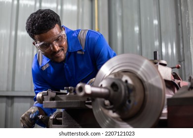 Engineering Worker Man African American Wearing Uniform Safety Working Machine Lathe Metal Brake Disc Grinder In Factory Industrial, Worker Manufacturing Industry Concept.