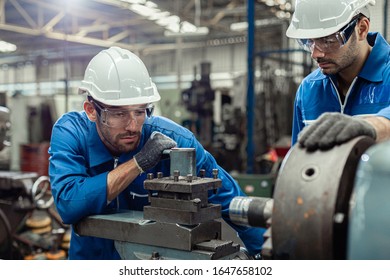 Engineering worker man wearing uniform safety and hardhat working machine lathe metal in factory industrial, worker manufactory industry concept. - Powered by Shutterstock