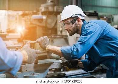 Engineering worker man wearing uniform safety and hardhat working machine lathe metal in factory industrial, worker manufactory industry concept. - Shutterstock ID 1904929258