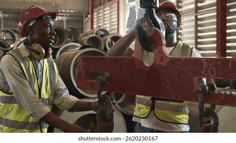 Engineering and worker training or explaining detail weight overhead cranelifting machine, two engineer checking the operation of crane in the factory, recruitment concept