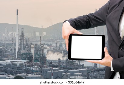 Engineering working hold tablet in front of oil refinery power station
