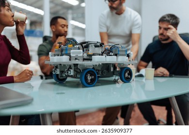 Engineers analyzing a robotics platform, discussing its performance and potential improvements in a bright, modern laboratory