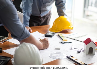 Engineers and businessmen are discussing and consulting with construction projects in workplace. Construction concept.