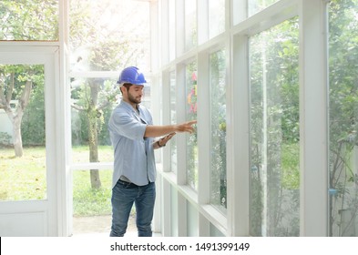 Engineers calculated the construction budget.

The young engineer review the construction. Old House Renovation. Architect checking design details.