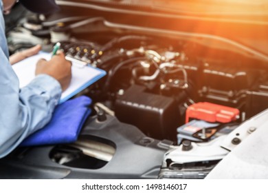 Engineers Check Car Conditions Before Departure. Light Is Golden At Sunset. Blur Image Men Employees Who Are Checking Engines.
Concept Of Quality Inspection Of Cars Engine Maintenance All The Time.