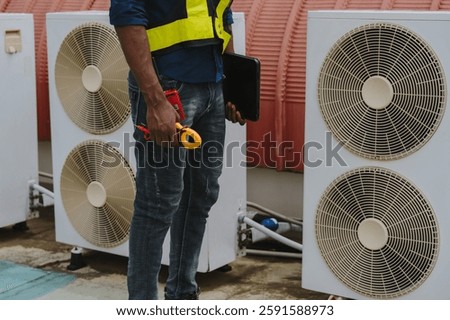 Engineers are checking the air conditioning and cooling system in a commercial building.	