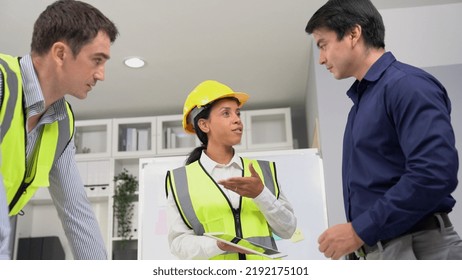 Engineers And Competent Employer Discussing Plans And Blueprints Together With Tablet In The Office. Concept Of Team Contribution Of Ideas For Engineering Project.