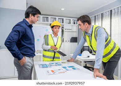 Engineers And Competent Employer Discussing Plans And Blueprints Together With Tablet In The Office. Concept Of Team Contribution Of Ideas For Engineering Project.