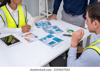 Engineers And Competent Employer Discussing Plans And Blueprints Together With Tablet In The Office. Concept Of Team Contribution Of Ideas For Engineering Project.