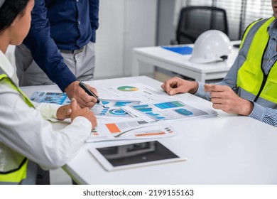 Engineers And Competent Employer Discussing Plans And Blueprints Together With Tablet In The Office. Concept Of Team Contribution Of Ideas For Engineering Project.