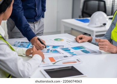 Engineers And Competent Employer Discussing Plans And Blueprints Together With Tablet In The Office. Concept Of Team Contribution Of Ideas For Engineering Project.