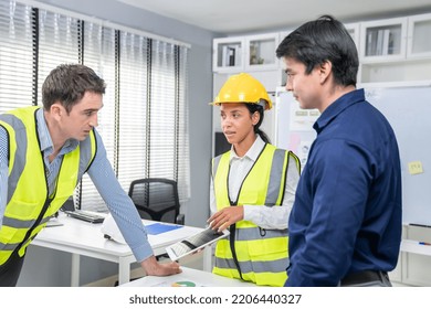 Engineers And Competent Employer Discussing Plans And Blueprints Together With Tablet In The Office. Concept Of Team Contribution Of Ideas For Engineering Project.