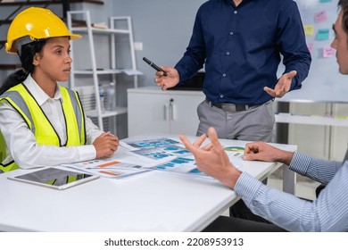 Engineers And Competent Employer Discussing Plans And Blueprints Together With Tablet In The Office. Concept Of Team Contribution Of Ideas For Engineering Project.