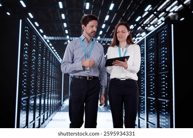 Engineers configuring AI technology in data center server room.