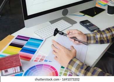 Engineers and creative artists work on table, work, consult, advise on choosing colors and materials, measuring size, choosing cool colors, soft tones, beautiful tones. - Shutterstock ID 1691073202