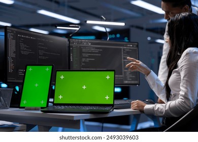 Engineers in data center using mockup tablet and laptop to check for server issues arising due to high CPU usage. Server hub workers fixing insufficient memory errors with green screen devices - Powered by Shutterstock - Get 15% off with code: PIKWIZARD15