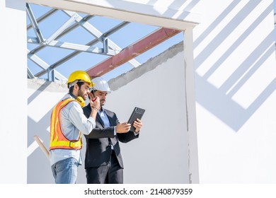Engineers are discussing data working and tablet or laptop with architectural project at new construction site,Engineering tools and construction concept.
