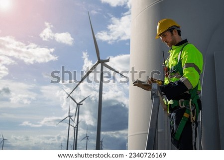 engineers are discussing maintenance of wind turbines. Clean energy. Alternative energy concept