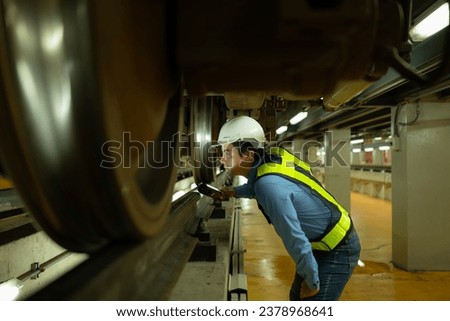Engineers for electric trains After detecting difficulties with the electric train's machinery use searchlights to locate and check damaged sections. In the electric train repair shop