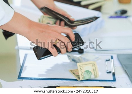Engineers and Foreman are calculating workers' expenses and overtime to pay workers compensation and overtime each month. Foreman holds cash in hand to pay workers as compensation