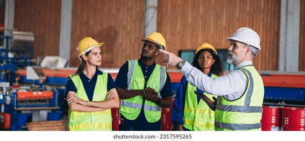 Engineers or foreman inspecting and check up machine at factory machines. Worker industry working in the metal sheet company. 