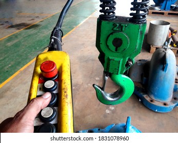 engineer's  hand holding overhead cranes remote in maintenance workshop, industrial concept. - Shutterstock ID 1831078960