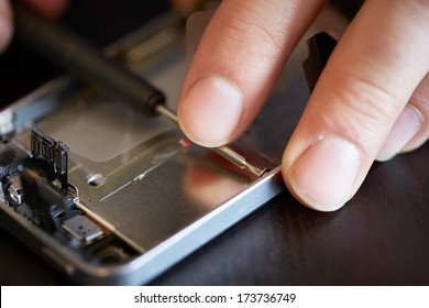 Engineers hands fixing smartphone close-up