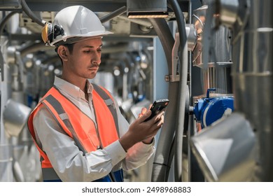 Engineers inspect gas and water pipes for power and cooling in industrial and building systems. workers in safety gear work seriously in oil and gas refining plant with pipes connecting to machinery. - Powered by Shutterstock