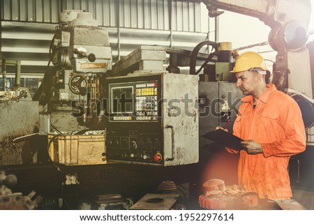 Engineers inspect old electrical control cabinet machines and equipment in the warehouse of an industrial factory selling second-hand machines.Record to file a report for information.