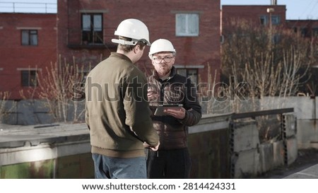Engineers Inspect Roofs. Engineers Collaboratively Examine And Quantify Roof And Climate Control Systems. Media