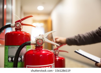 Engineers Are Inspecting Fire Extinguisher For Prevention And Emergency Preparedness.