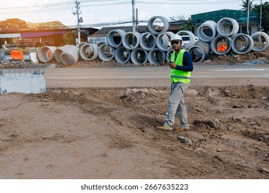 Engineers are inspecting the readiness and completeness of a large construction project involving pipe laying and road construction.Civil engineer,construction,roadconstruction,engineer,drainage pipe.