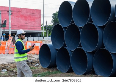 Engineers are inspecting the readiness and completeness of a large construction project involving pipe laying and road construction.Civil engineer,construction,roadconstruction,engineer,drainage pipe.