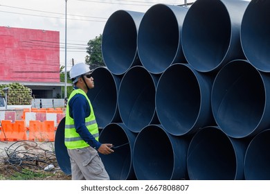 Engineers are inspecting the readiness and completeness of a large construction project involving pipe laying and road construction.Civil engineer,construction,roadconstruction,engineer,drainage pipe.