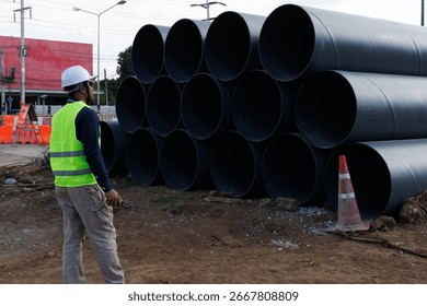 Engineers are inspecting the readiness and completeness of a large construction project involving pipe laying and road construction.Civil engineer,construction,roadconstruction,engineer,drainage pipe.