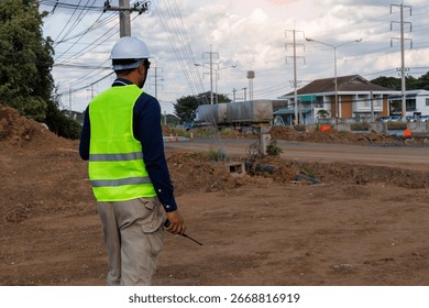 Engineers are inspecting the readiness and completeness of a large construction project involving pipe laying and road construction.Civil engineer,construction,roadconstruction,engineer,drainage pipe.