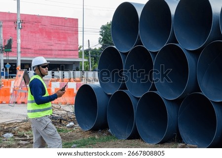 Engineers are inspecting the readiness and completeness of a large construction project involving pipe laying and road construction.Civil engineer,construction,roadconstruction,engineer,drainage pipe.