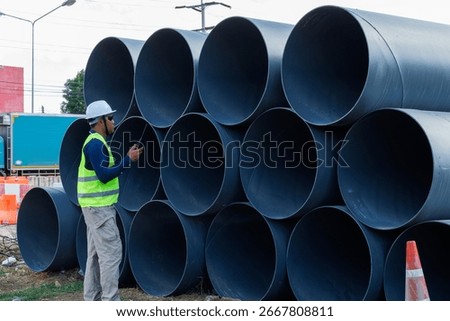 Engineers are inspecting the readiness and completeness of a large construction project involving pipe laying and road construction.Civil engineer,construction,roadconstruction,engineer,drainage pipe.