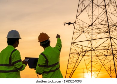 Engineers location help Technician use drone to fly inspections at the electric power station to view the planning work by producing electricity high voltage electric transmission tower at sunset - Powered by Shutterstock