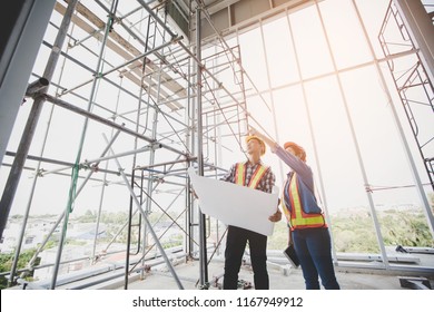 Engineers are meeting and pointing to new construction sites, Engineering tools and construction concept. - Shutterstock ID 1167949912