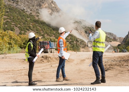 Engineers on construction site. Industrial blasting at a construction site