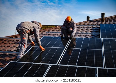 Engineers on the roof of house are checking solar cells in the autumn. Technician worker on solar panels
