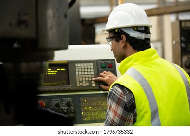 Engineers operating a machine in factory
