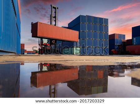 Engineers are overseeing the transportation of cargo with containers inside the warehouse. Container in export and import business and logistics.