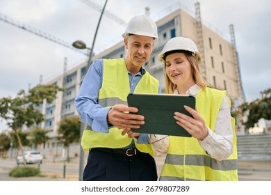 Engineers planning construction project using digital tablet